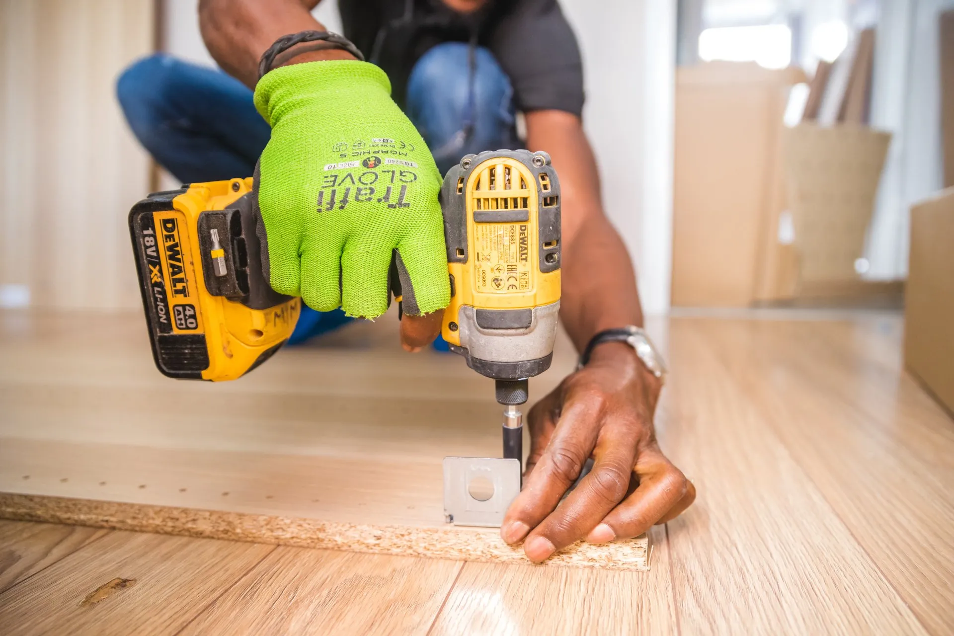 a picture of a man holding a drill and a screw on the floor, Chalmette, LA